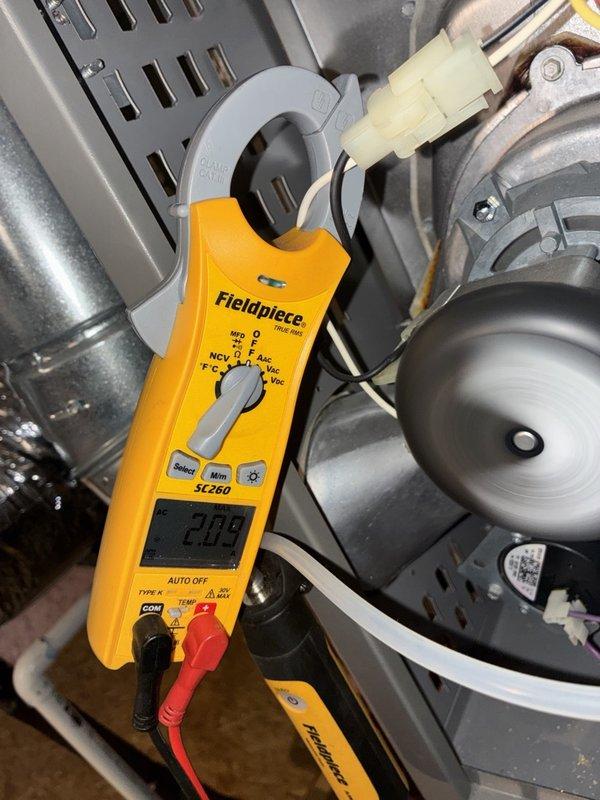 Performed a fall heating tune-up on one system, inspecting the furnace cabinet, control board wiring, and inducer/blower assembly for proper operation. Verified electrical performance with a clamp meter, measuring approximately 2.09 amps on the motor circuit, and observed the motor running smoothly. No signs of rust, frost, or damage were found, and the system was left operating normally.