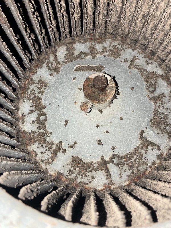 Performed a pre-sale HVAC inspection on the AC and heating system, evaluating heater operation based on the reported heating issue. Inspection of the air handler revealed a blower wheel heavily caked with dust and debris, a corroded shaft collar and set screw, and rust and heavy buildup throughout the blower housing, all of which restrict airflow and can contribute to heating performance problems. Recommend cleaning or replacing the blower assembly and addressing the corroded components.