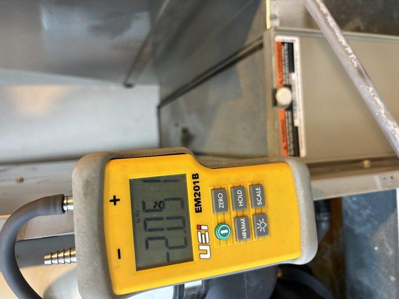 Responded to no heat complaint on 10+ year old system. Performed gas pressure testing with UEi EM201B manometer, measuring inlet pressure at 1.7" WC and outlet pressure at 20.5" WC. Confirmed system is now functioning properly after adjusting gas pressure to manufacturer specifications.