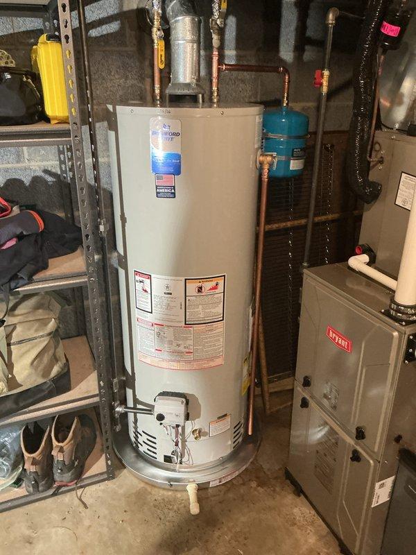 Successfully installed new gas water heater in basement location with proper venting and connection to existing gas line. Installed blue expansion tank on copper supply piping and ensured all connections were secure and leak-free. System was tested and confirmed to be operating correctly with appropriate temperature settings and safety features functioning as designed.