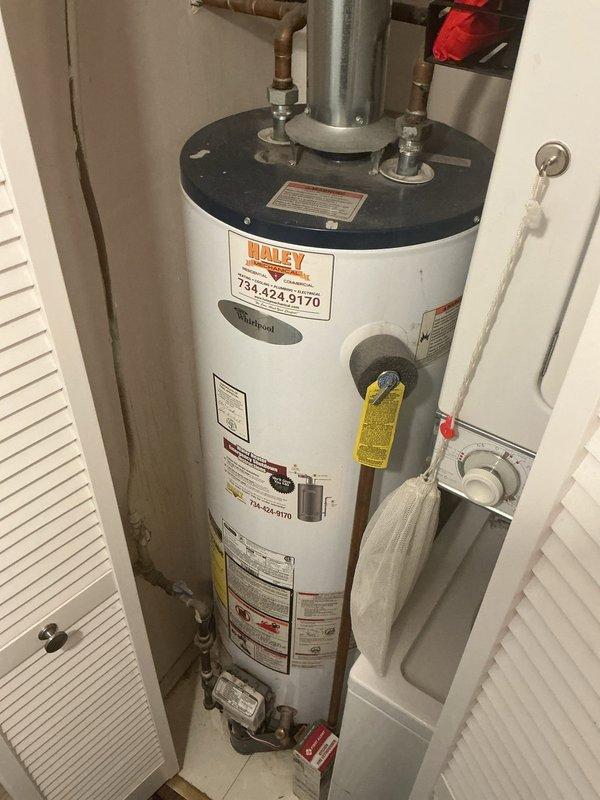 Responded to service call for Whirlpool tanked water heater not producing hot water. Diagnosed faulty thermostatic control component and replaced defective parts. System now functioning properly with restored hot water output; verified proper venting and connection integrity of copper supply lines.
