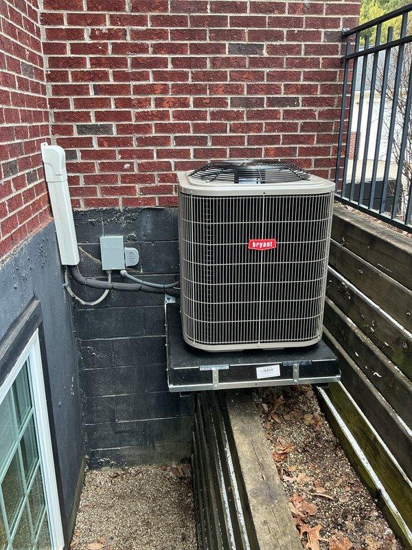 Successfully installed a complete Bryant HVAC system, including an indoor furnace unit with properly routed PVC exhaust/intake ventilation and an outdoor condenser mounted on an elevated platform. System features include appropriate ductwork connections, refrigerant lines, and electrical hookups, with all components tested for proper operation before completion.