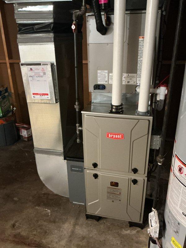 # HVAC Install - Furnace Summary

Successfully completed installation of new Bryant gas furnace system in residential basement mechanical room. Installation included proper venting with white PVC piping, connection to existing ductwork system with metal and flexible ducts, and exterior termination through concrete block wall with appropriate vent cap. All electrical connections, gas line hookups, and safety controls were installed per manufacturer specifications and local code requirements. System was tested for proper operation, combustion efficiency verified, and all safety devices confirmed functional.