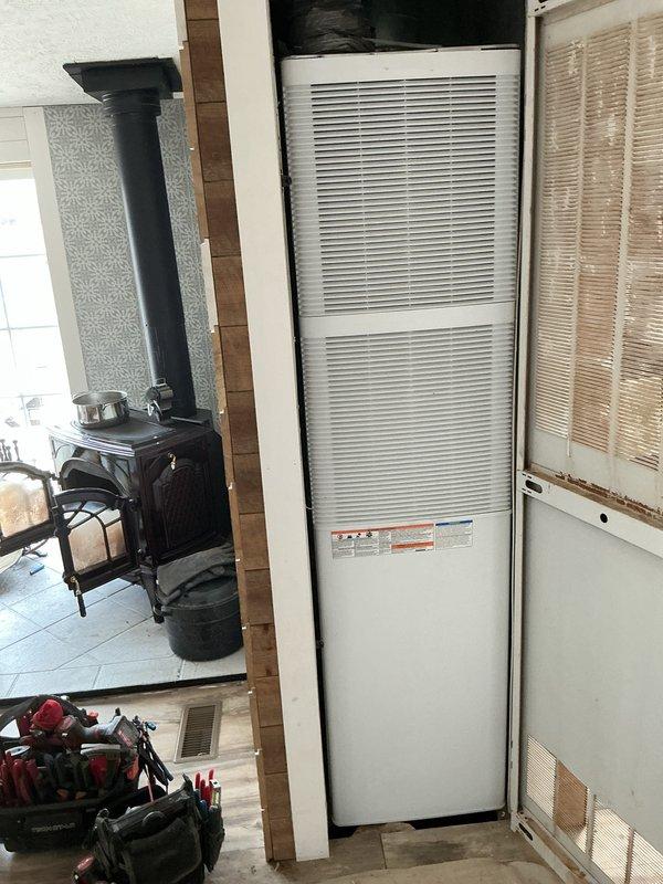 # HVAC Install - Complete System

## Job Description

Successfully completed full HVAC system installation in mobile home, including gas furnace and air conditioning unit. Interior furnace unit installed in main living area with proper clearances maintained from existing wood stove and combustible materials. Unit secured to floor with appropriate mounting, refrigerant lines and electrical connections completed to manufacturer specifications. Exterior Bryant condenser unit positioned on level gravel pad with vibration-dampening base, mounted adjacent to structure with electrical disconnect box installed per code requirements. All refrigerant lines properly insulated, system charged to specifications, and tested for proper operation. Ductwork connections verified, airflow balanced, and thermostat wiring completed. System startup performed with all safety controls and operational parameters confirmed within normal range.