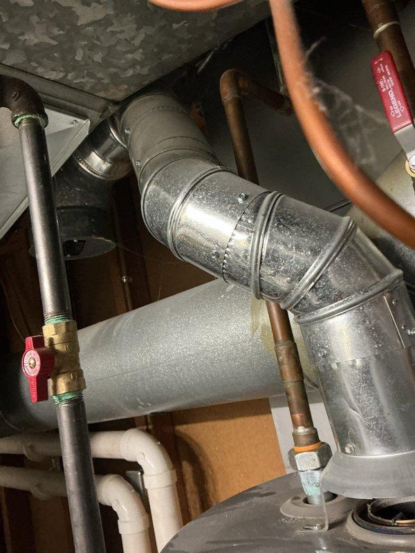 # Water Heater Replacement

Responded to service call for non-functional water heater in 10-year-old residential property. Upon inspection, determined existing unit had reached end of serviceable life at approximately 10 years of age. Removed and disposed of old water heater. Installed new Rheem Performance Plus residential water heater with proper venting configuration. Connected copper supply lines to hot and cold water ports with appropriate shut-off valves for future serviceability. Installed temperature and pressure relief valve per manufacturer specifications and code requirements. Configured metal exhaust ductwork to ensure proper ventilation of combustion gases. Verified all electrical connections to control components. Tested unit operation, confirmed proper heating function, and checked for leaks at all connection points. System restored to full operational status.