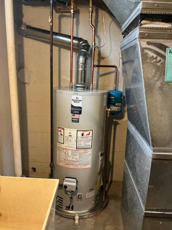 # Water Heater Replacement

Removed and replaced existing water heater with a new 40-gallon Bradford White short model natural gas unit rated at 40,000 BTU/Hr. Installation included a new drain pan for leak protection and comprehensive code compliance upgrades to meet current plumbing standards. All copper supply lines were properly connected with secure mounting brackets, and the Category I natural draft venting system was installed per manufacturer specifications. Obtained and finalized mechanical permit for the installation. The unit is now fully operational with proper hot and cold water connections, appropriate inlet/outlet supply pressures, and all safety controls functioning correctly. Installation meets ANSI/NFPA standards and includes manufacturer warranty coverage.