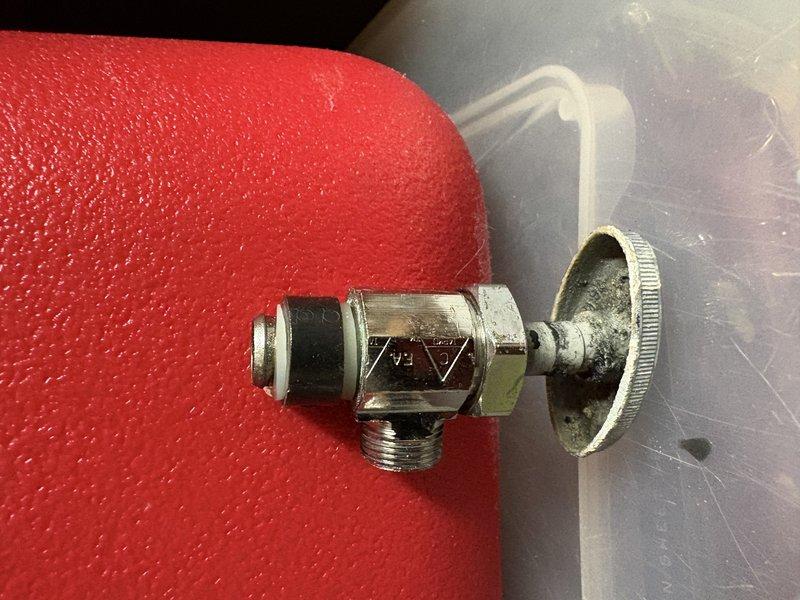 Responded to service call for leaking plumbing valve in attic space. Upon inspection, identified failed chrome-plated manifold valve at PEX piping junction point mounted to ceiling joists. Valve showed signs of wear with compromised gasket causing active leak. Documented existing installation with photos showing multi-port manifold configuration and valve assembly details. Coordinated parts procurement for replacement valve matching existing specifications. Scheduled follow-up appointment to complete valve replacement once replacement part arrives.