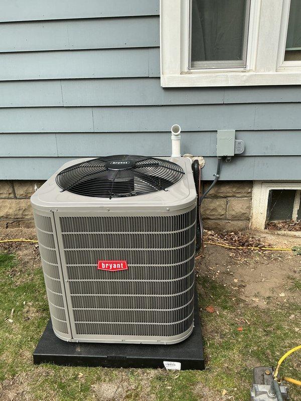 Completed full HVAC system installation including new Bryant air conditioning condenser unit and furnace. Positioned outdoor condenser on composite pad against exterior wall with proper clearances, installed electrical disconnect box, and ran refrigerant lines, condensate drain (PVC), and electrical connections through exterior wall. Connected all refrigerant piping with proper insulation, verified electrical connections meet code requirements, and ensured proper drainage routing. System tested and confirmed operational with normal airflow and cooling capacity.