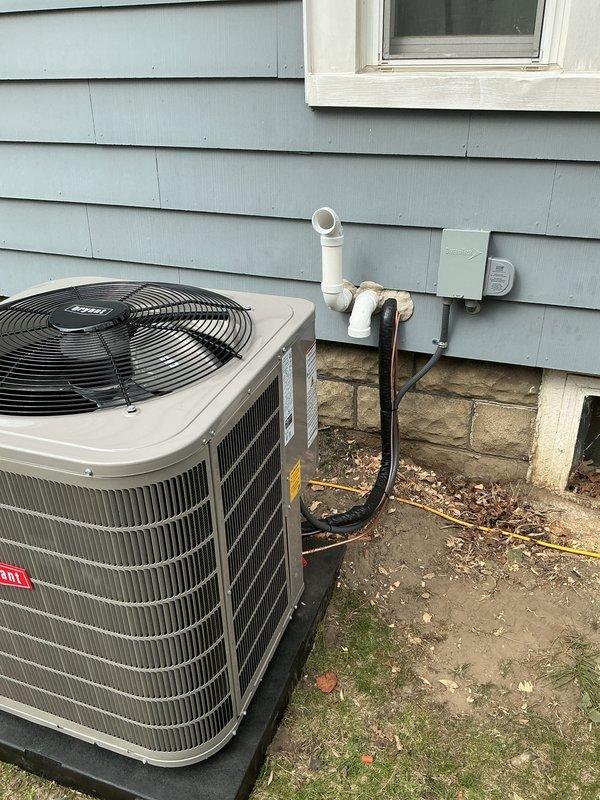 Completed full HVAC system installation including new Bryant air conditioning condenser unit and furnace. Positioned outdoor condenser on composite pad against exterior wall with proper clearances, installed electrical disconnect box, and ran refrigerant lines, condensate drain (PVC), and electrical connections through exterior wall. Connected all refrigerant piping with proper insulation, verified electrical connections meet code requirements, and ensured proper drainage routing. System tested and confirmed operational with normal airflow and cooling capacity.