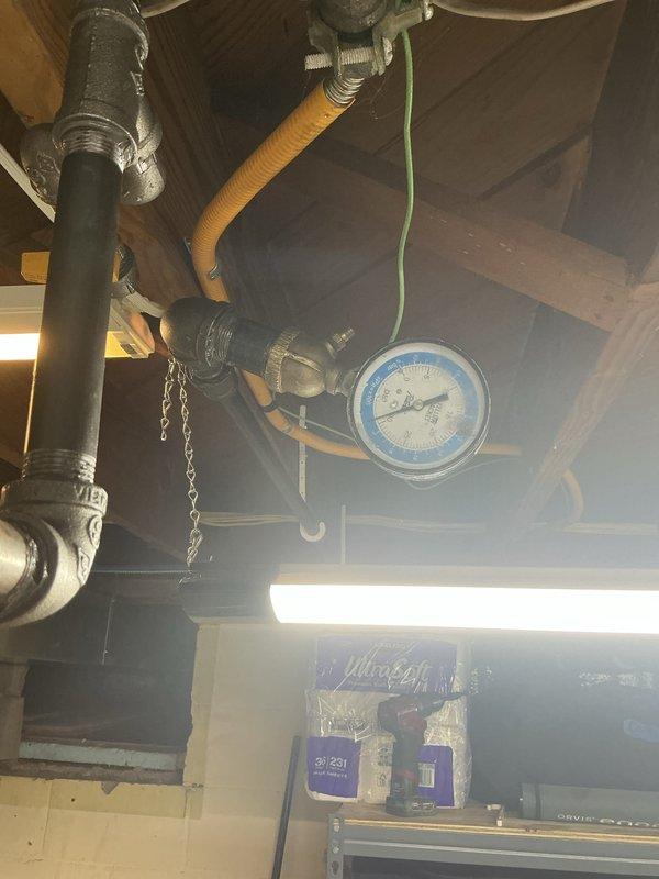 Installed a new Bradford White gas-fired water heater in basement utility area, including all necessary plumbing connections with copper piping and brass fittings at the unit's inlet and outlet. Configured proper venting system with metallic exhaust pipe, installed pressure relief valve with discharge piping, and integrated pressure tank into the system. Additionally, ran new gas piping from existing supply to accommodate outdoor grill installation, ensuring all connections meet code requirements and proper gas flow to both appliances.
