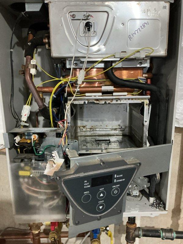 Responded to new customer service call for leaking tankless water heater. Upon arrival, performed diagnostic inspection of wall-mounted unit and identified source of water leak from internal components. Removed front access panel to examine heat exchanger assembly, copper piping connections, and pressure relief valves. Documented existing conditions showing signs of operational wear and confirmed active leak requiring repair. Assessed all plumbing connections, shut-off valves, and internal mechanical systems to determine extent of necessary repairs and provide customer with repair options for resolution.