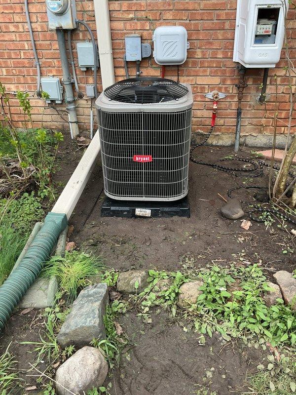 Completed installation of new air conditioning system including outdoor condenser unit and indoor evaporator coil. Outdoor unit was positioned on level pad against exterior brick wall with proper clearances, connected to existing electrical disconnect and properly wired to building power supply. Inside mechanical space, installed new evaporator coil with insulated refrigerant lines, integrated into existing ductwork system using flexible metallic transition duct, and connected condensate drain line. All refrigerant connections were brazed, system was pressure tested for leaks, evacuated to proper vacuum levels, and charged with refrigerant to manufacturer specifications. Verified proper airflow, temperature differential, and system operation upon startup.