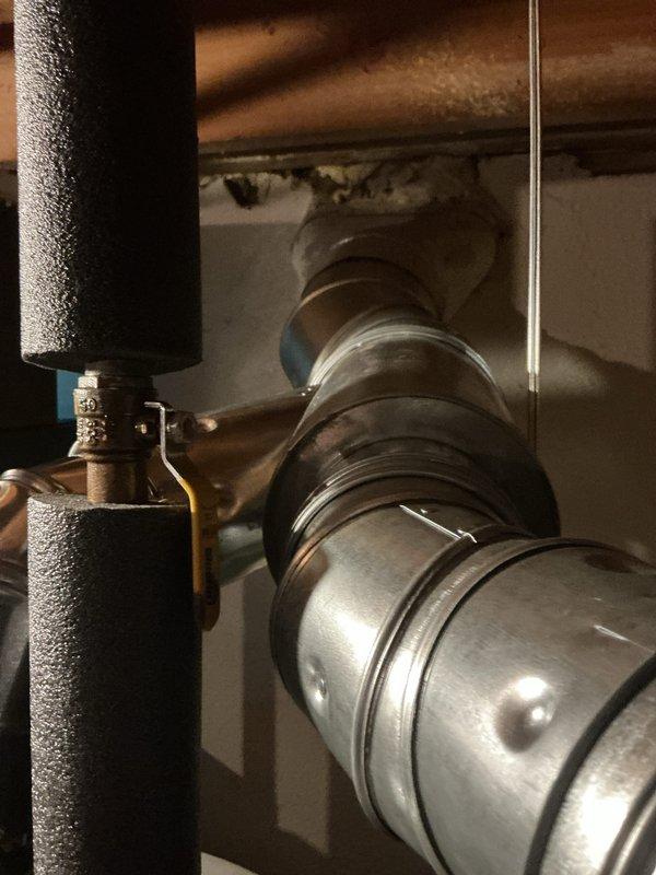 Completed installation of new air conditioning system including outdoor condenser unit and indoor evaporator coil. Outdoor unit was positioned on level pad against exterior brick wall with proper clearances, connected to existing electrical disconnect and properly wired to building power supply. Inside mechanical space, installed new evaporator coil with insulated refrigerant lines, integrated into existing ductwork system using flexible metallic transition duct, and connected condensate drain line. All refrigerant connections were brazed, system was pressure tested for leaks, evacuated to proper vacuum levels, and charged with refrigerant to manufacturer specifications. Verified proper airflow, temperature differential, and system operation upon startup.