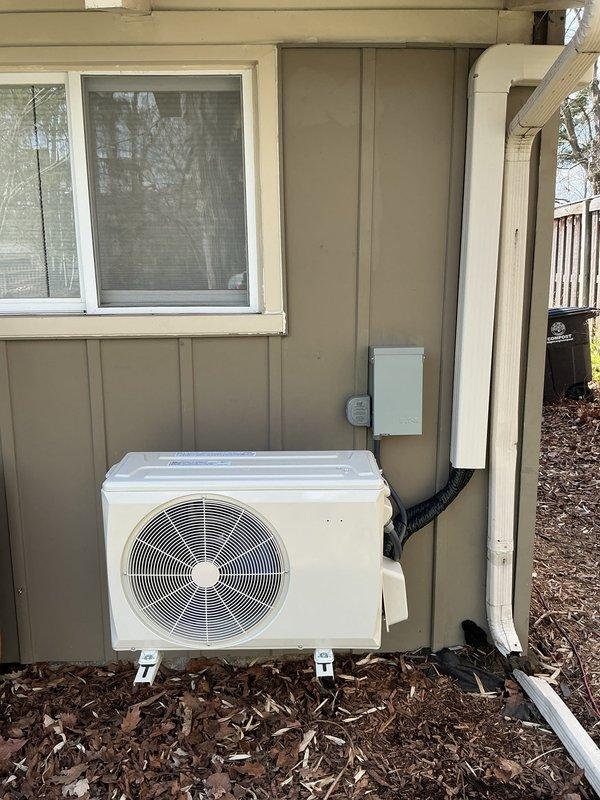 Completed installation of two air conditioning systems and one ductless mini-split unit at residential property. Mounted outdoor mini-split condenser unit on exterior wall using bracket system, installed refrigerant line set with PVC line hide, and ran electrical conduit to disconnect box. Interior mini-split air handler installed on wall near ceiling with proper refrigerant connections, condensate drainage, and electrical wiring. All units tested for proper operation, refrigerant charge verified, and system performance confirmed to manufacturer specifications.