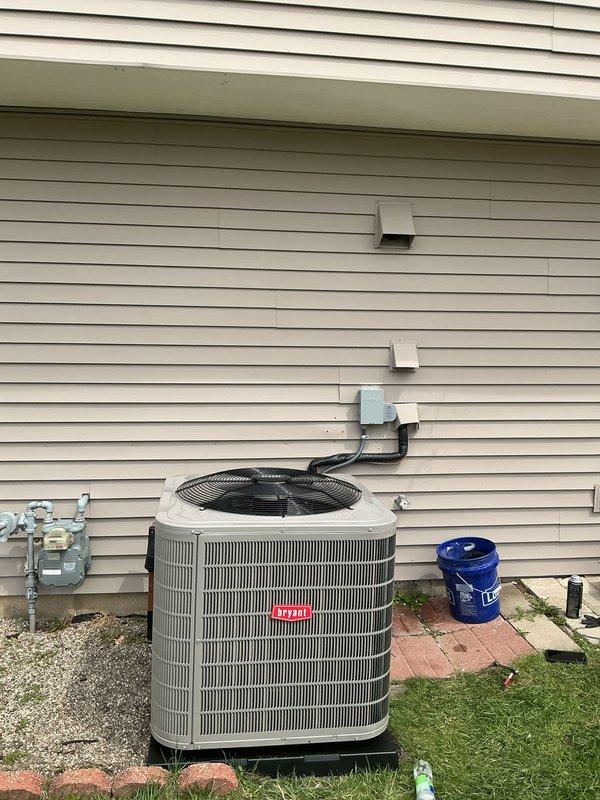 Completed installation of new Bryant air conditioning system with matching evaporator coil. Installed outdoor condensing unit on exterior pad with proper clearances, ran refrigerant lines and electrical connections to indoor coil mounted above existing furnace, established proper drainage through PVC piping, performed startup procedures, and verified system operation with proper airflow and temperature differential across the coil.