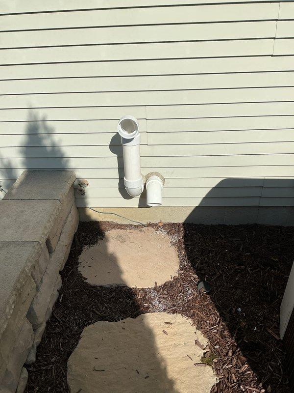 Completed installation of new gas furnace in residential basement utility room. Unit was positioned on tiled floor with proper clearances, connected white PVC intake and exhaust venting routed vertically through ceiling joists, and terminated venting system through exterior wall with appropriate horizontal termination and weather protection. All installations meet code requirements for combustion air and venting specifications.