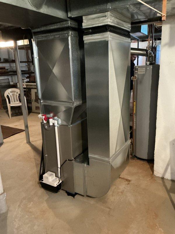 Completed installation of a new Bryant gas furnace in residential basement mechanical room. Unit was positioned on concrete floor with proper clearances, connected to existing ductwork system, and integrated with PVC condensate drainage assembly featuring shutoff valves for future maintenance access. All electrical connections, gas line hookups, and venting were installed per manufacturer specifications and local code requirements, with system tested and verified operational upon completion.