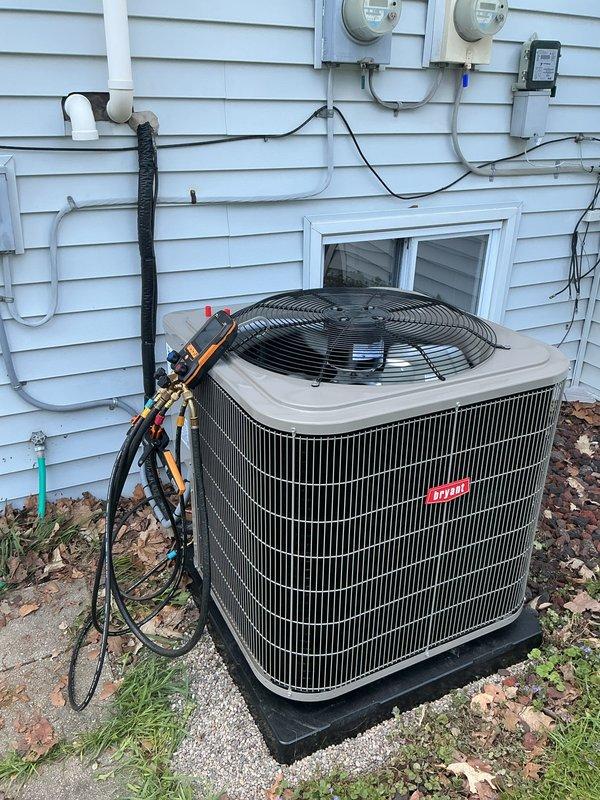 Completed full HVAC system installation including new Bryant furnace and air conditioning condenser unit. Installed outdoor condensing unit on pad with proper grounding, connected refrigerant lines with insulation, established electrical connections with disconnect box, and routed PVC condensate drainage. Indoor installation included furnace placement, air handler/plenum assembly, refrigerant line connections, and metal ductwork integration with proper insulation. All components mounted on concrete foundation, system tested and verified operational.