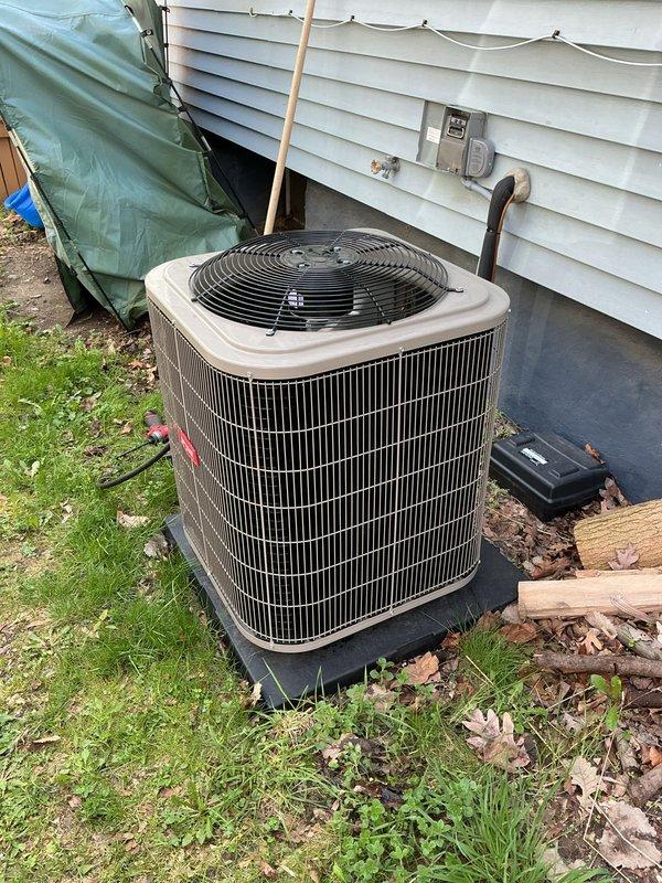 Completed air conditioning system installation and performed initial start-up procedures. Installed outdoor condenser unit on concrete pad with proper clearances, established refrigerant line connections through exterior wall penetration, and verified electrical connections to outdoor disconnect. System was energized, operational parameters were tested and confirmed within manufacturer specifications, and unit was left running properly.
