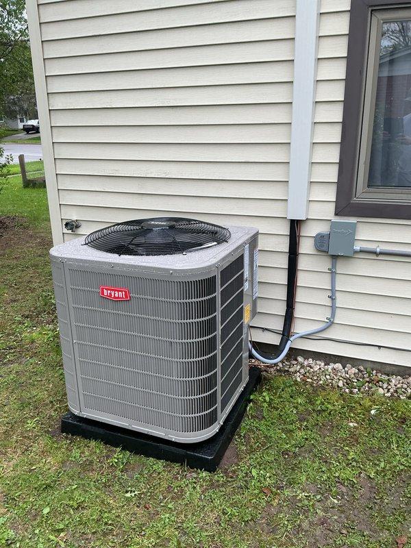 Completed full HVAC system installation including Bryant brand air conditioning unit, Bradford White water heater, furnace, and electrical service upgrades. The outdoor AC condenser was positioned on a stabilizing pad with proper clearances from the structure, electrical conduit securely mounted to exterior siding, and refrigerant lines professionally routed. Inside the mechanical room, installed new water heater with proper copper piping connections, brass fittings, and blue expansion tank for thermal expansion protection. All equipment installations meet manufacturer specifications and local building codes, with systems tested and confirmed operational upon completion.