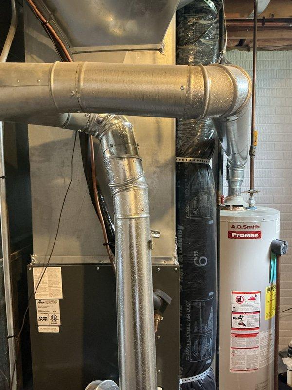Responded to basement water leak of unknown origin with diagnostic service requested. Upon arrival, inspected A.O. Smith ProMax tanked water heater and surrounding water softener equipment in mechanical room. Conducted thorough visual inspection of water heater connections, including copper supply lines, shut-off valves, pressure relief system, and venting components. Examined all visible piping, connections, and floor area around both water heater and adjacent HVAC equipment to identify leak source. Documented equipment condition with photographs showing water heater installation, plumbing connections, and utility room configuration. Provided diagnostic findings and prepared replacement quote for water heater as requested by homeowner.