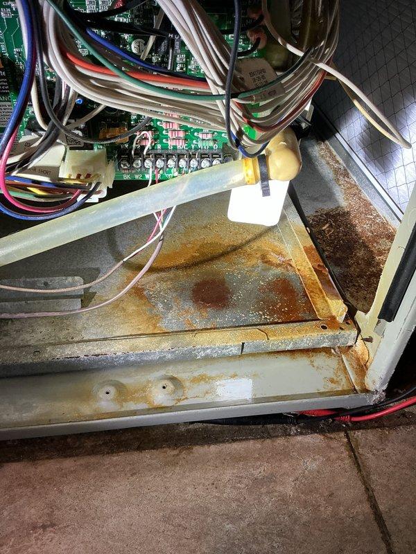 Completed scheduled air conditioning tune-up and preventative maintenance inspection. Upon accessing the air handler unit, observed extensive rust corrosion on the condensate drain pan with significant mineral deposits and water staining, indicating prolonged moisture exposure. Inspected control board, electrical connections, and wiring harness; noted corrosion present on metal brackets and connection points that will require monitoring. All electrical components tested and functioning within normal parameters at time of service.