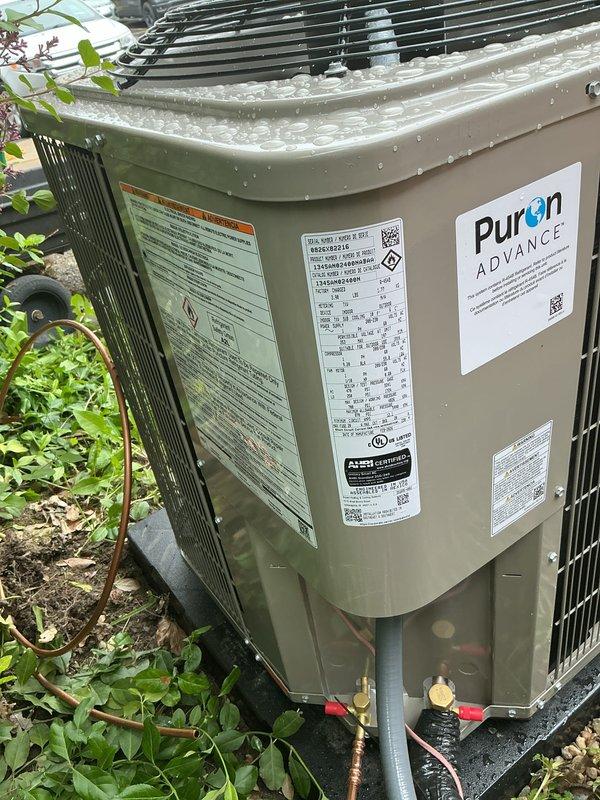 Completed installation of new Puron ADVANCE air conditioning condenser unit and evaporator coil system. Unit was positioned on concrete pad with proper clearances, refrigerant lines were connected and insulated, and all electrical connections were made per manufacturer specifications. System was tested and verified operational with no leaks detected.