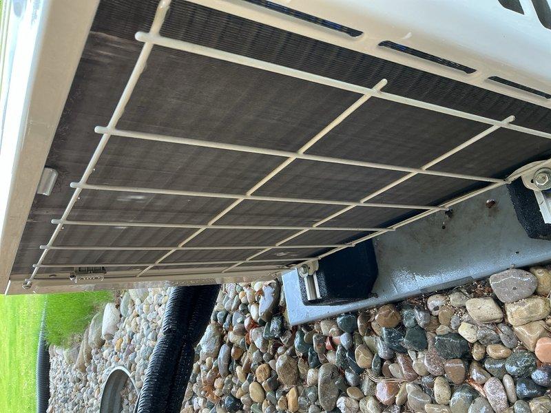 Performed comprehensive air conditioning tune-up on outdoor condensing unit. Inspected unit exterior, coil condition, and mounting hardware; verified proper airflow through condenser grille and confirmed unit operational status. Collected payment for service agreement renewal and documented equipment condition with photographs.