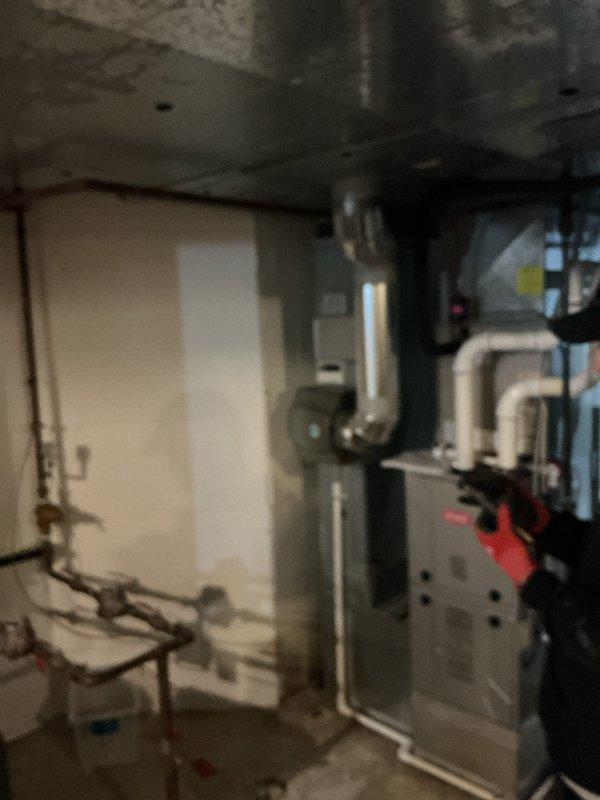 Completed installation of whole-home humidifier system integrated with existing HVAC equipment. Unit was properly mounted, connected to water supply via copper and PVC piping routed through ceiling structure, and wired to furnace for coordinated operation. Customer notified of estimated arrival window and installation was performed following completion of bathroom exhaust work.