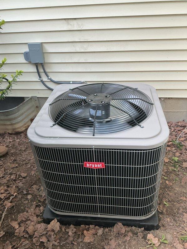 Completed installation of new Bryant outdoor air conditioning condenser unit and Lennox indoor air handler system. Positioned condenser on pad against exterior wall with proper clearances, ran electrical conduit from junction box to unit, and established refrigerant line connections. Installed indoor air handler above existing furnace in basement mechanical room, integrated ductwork connections with black flexible duct, and verified all electrical components including disconnect switch were properly mounted and operational. System tested and confirmed operational with no leaks detected in refrigerant lines.