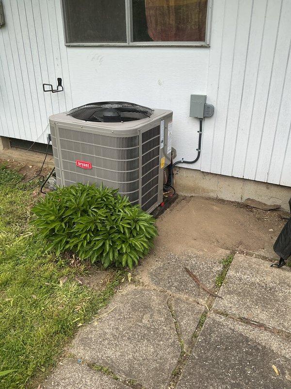 Completed full HVAC system installation including new Bryant air conditioning condenser unit, furnace, and humidifier. The outdoor condenser was positioned on existing concrete pad against building exterior with proper clearances maintained for airflow and service access. Installed electrical disconnect box with appropriate conduit routing to meet code requirements. All refrigerant lines were properly sized and insulated, with penetrations through building envelope sealed to prevent air and moisture infiltration. Indoor furnace and humidifier were installed and integrated with existing ductwork, ensuring proper venting and condensate drainage. System was charged to manufacturer specifications, electrical connections verified, and all components tested for proper operation. Final startup completed with system running within normal operating parameters.