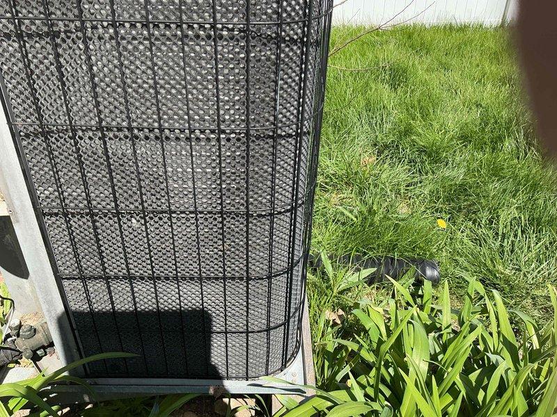 Completed comprehensive AC tune-up on residential heat pump unit with protective mesh cage enclosure. Performed standard maintenance inspection, verified system operation, and documented equipment condition with photos showing unit properly positioned on concrete pad with adequate clearance from landscaping.