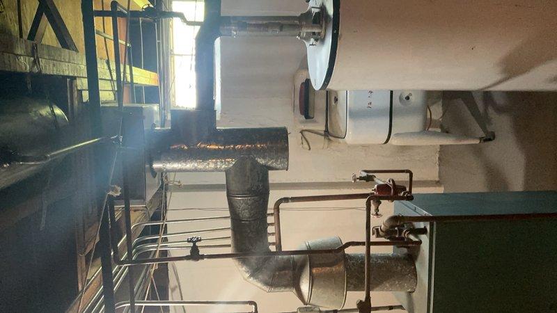 Performed comprehensive pre-purchase boiler system evaluation for prospective home buyers. Conducted thorough inspection of existing boiler, water heater, expansion tank, and associated piping systems in mechanical room. Documented equipment condition noting visible corrosion on ductwork and aging infrastructure, photographed all major components, and provided overview of system functionality with recommendations for potential repairs or replacement considerations.