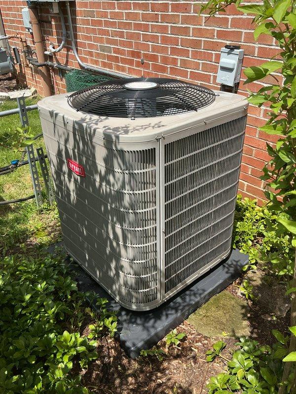 Completed scheduled air conditioning tune-up and preventative maintenance service on residential outdoor condenser unit. Performed comprehensive system inspection, noting accumulated dirt and debris on condenser coil fins with visible discoloration and environmental buildup affecting heat transfer efficiency. Unit operational and positioned on proper pad with adequate clearance from surrounding vegetation and structures.