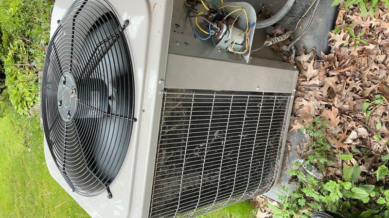 Performed comprehensive tune-up on outdoor condensing unit, including inspection of compressor, fan motor, and electrical connections. Verified proper operation of condenser coils with horizontal louvers, checked refrigerant lines and wiring harness, and confirmed fan assembly function. Unit operating within normal parameters upon completion of preventive maintenance service.