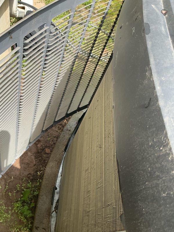 Completed comprehensive AC tune-up and maintenance service on a 2-year-old air conditioning system. Performed thorough inspection of outdoor condenser unit, which revealed significant accumulation of dirt, dust, and organic debris on condenser coils and unit base. Cleaned condenser coils to restore optimal heat transfer efficiency, removed debris buildup from base and surrounding areas, and verified system operation. All components tested and confirmed functioning properly upon completion.