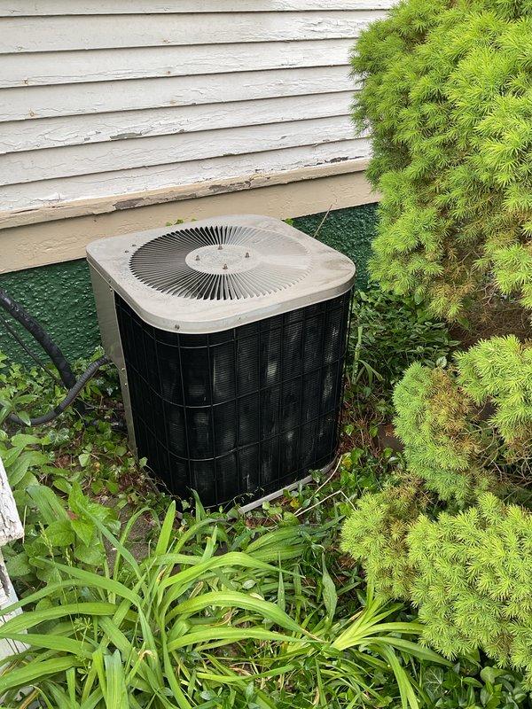 Completed comprehensive air conditioning tune-up and system evaluation on outdoor condensing unit as part of annual heating/cooling maintenance membership renewal. Performed full inspection of cylindrical condenser unit with verification of electrical disconnect functionality, assessed refrigerant levels, cleaned components, and confirmed proper airflow through fan assembly. All systems operating within normal parameters with no deficiencies noted at time of service.