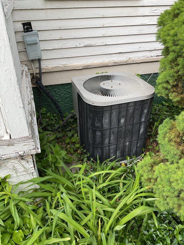 Completed comprehensive air conditioning tune-up and system evaluation on outdoor condensing unit as part of annual heating/cooling maintenance membership renewal. Performed full inspection of cylindrical condenser unit with verification of electrical disconnect functionality, assessed refrigerant levels, cleaned components, and confirmed proper airflow through fan assembly. All systems operating within normal parameters with no deficiencies noted at time of service.