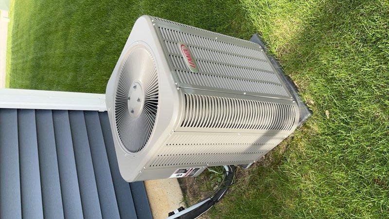 Completed comprehensive air conditioning tune-up on outdoor condensing unit positioned on artificial turf beside building. Performed standard maintenance protocol including inspection of compressor, capacitor, electrical connections, and control components; verified proper wire routing and connections; cleaned condenser coils; checked refrigerant lines; and confirmed unit operational status. Customer reinstated preventative maintenance membership program during this service visit.