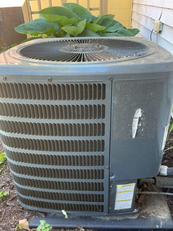 # HVAC Maintenance Completed

Performed comprehensive annual air conditioning tune-up and preventative maintenance on residential outdoor condensing unit. System inspection revealed unit in operational condition with age-related weathering and surface accumulation present on exterior cabinet.

## Work Performed

Conducted complete visual inspection of outdoor condenser unit, noting weathered exterior finish and dirt accumulation on metal cabinet and fan grille. Accessed electrical compartment to inspect internal components, wiring connections, and capacitor. Verified proper wire terminations on red, yellow, and purple conductors at connection points.

Inspected condenser coil through louvered side panels for blockage and debris. Evaluated fan motor assembly and fan blade condition through top grille guard. Checked unit mounting on concrete pad for stability and proper levelness.

Assessed electrical disconnect and line set routing along building exterior. Verified adequate clearance ar