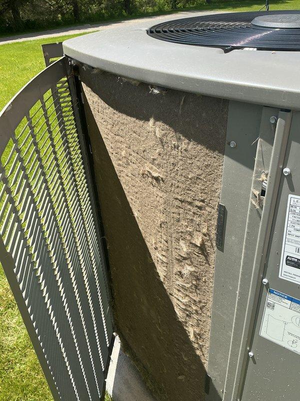 Performed comprehensive AC tune-up on 2022 residential unit as part of prepaid maintenance agreement. Inspected outdoor condenser unit, which showed moderate accumulation of dirt, dust, and organic debris on exterior panels and intake areas. Opened access panel to examine filter screen, noting typical dirt buildup consistent with normal operation. Completed standard maintenance procedures including visual inspection of all accessible components, fan grille assessment, and verification of unit specifications. System operational and ready for cooling season.