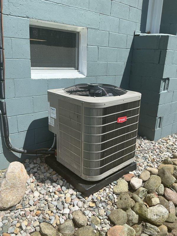 Completed full HVAC system installation including Bryant furnace, air conditioning condenser unit, and humidifier. Installed outdoor AC condenser on gravel pad with proper refrigerant line routing and electrical disconnect, positioned furnace in utility area with dual white PVC venting pipes for intake and exhaust, and integrated humidifier into ductwork system. Performed system startup procedures, verified proper operation of all components, confirmed adequate airflow, and ensured all equipment met manufacturer specifications and code requirements.