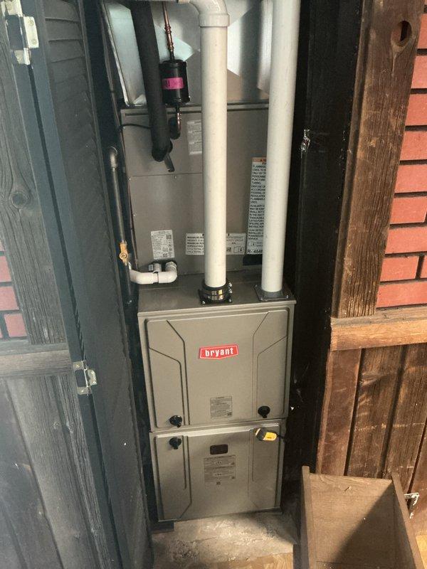 Completed full HVAC system installation including Bryant furnace, air conditioning condenser unit, and humidifier. Installed outdoor AC condenser on gravel pad with proper refrigerant line routing and electrical disconnect, positioned furnace in utility area with dual white PVC venting pipes for intake and exhaust, and integrated humidifier into ductwork system. Performed system startup procedures, verified proper operation of all components, confirmed adequate airflow, and ensured all equipment met manufacturer specifications and code requirements.