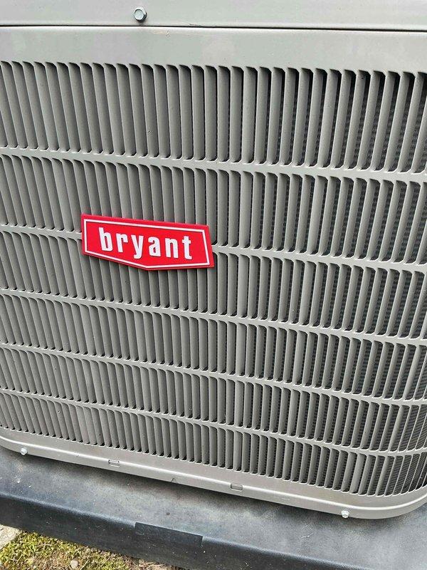 Completed scheduled air conditioning tune-up on Bryant outdoor condensing unit. Performed comprehensive system inspection, verified proper operation of all components, and documented unit condition with photographs showing equipment in good working order with clean exterior surfaces and no visible damage or deterioration to housing or grille assembly.