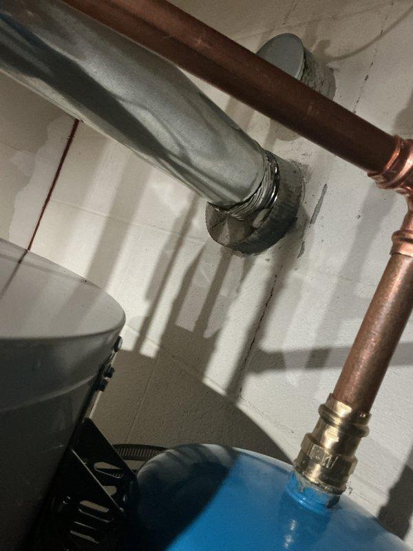 Completed installation of 50-gallon tanked water heater in utility room. Connected supply and discharge lines using copper piping with proper fittings and secured all lines to wall with appropriate mounting brackets. Installed insulated pipe runs and pressure relief valve assembly, ensuring all connections meet code requirements and system is operational.