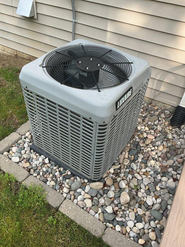 Completed annual AC tune-up and preventative maintenance on three outdoor Luxaire condenser units installed at residential property. Performed comprehensive system inspection, verified proper operation of all units, and documented equipment condition with photographs showing units in good working order with clean installations on rock beds.
