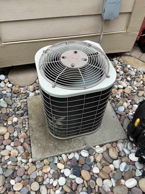 Completed routine air conditioning maintenance on a 17-20 year old single-stage condenser unit. Performed comprehensive tune-up including inspection of fan motor assembly, verification of proper airflow through condenser coil, electrical connection assessment at junction box, refrigerant level evaluation, and operational testing of all components. Unit found to be operating within normal parameters with no deficiencies noted; equipment remains in serviceable condition despite age.