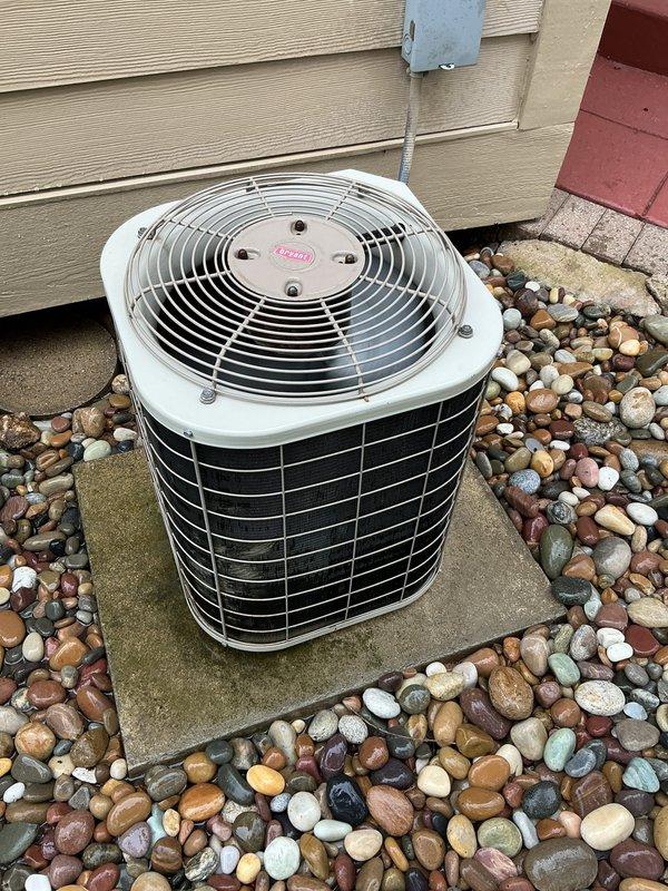 Completed routine air conditioning maintenance on a 17-20 year old single-stage condenser unit. Performed comprehensive tune-up including inspection of fan motor assembly, verification of proper airflow through condenser coil, electrical connection assessment at junction box, refrigerant level evaluation, and operational testing of all components. Unit found to be operating within normal parameters with no deficiencies noted; equipment remains in serviceable condition despite age.