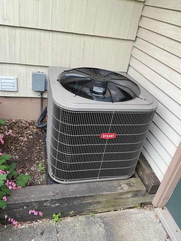 Completed system start-up and commissioning for newly installed HVAC equipment including Bryant air conditioning condenser, furnace, and humidifier. Verified proper refrigerant charge, airflow, electrical connections, and condensate drainage on outdoor unit mounted on wooden platform base. Replaced existing thermostat with upgraded model per customer request, providing multiple options for selection. All equipment tested and confirmed operational within manufacturer specifications.
