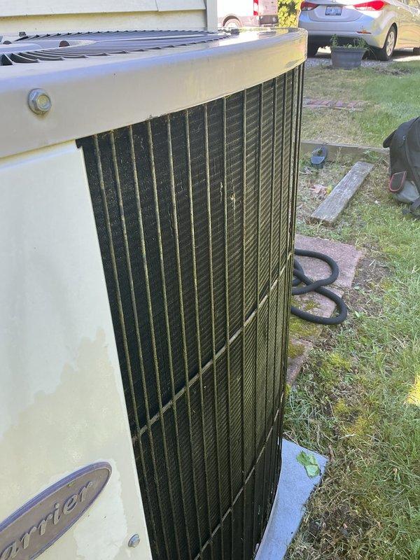 Completed scheduled air conditioning tune-up and preventative maintenance on residential outdoor condenser unit. Performed comprehensive system inspection, cleaned condenser coils showing significant dirt and debris accumulation on vertical fins, verified proper operation of all components, and ensured unit was functioning efficiently for the cooling season.